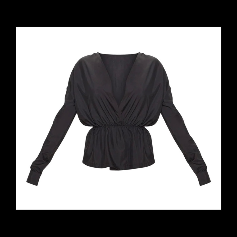 Featuring a black woven material with an elasticated waistband and long sleeves.